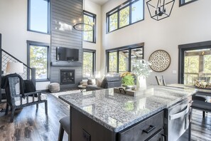 Enjoy cooking in this well-equipped kitchen with a large island and fireplace.