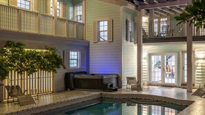 A pool area with a hot tub, seating, and a covered patio. - Luxe Mansion/10min Walk Beach/Gameroom/Heated pool (Hollywood)