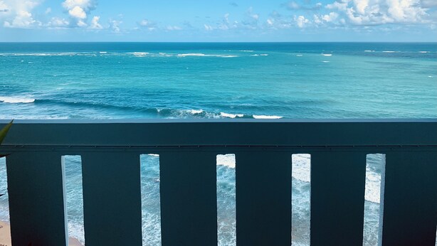 A view of the ocean from a balcony with a railing. - Oceanfront on 17th Floor in Condado (San Juan)
