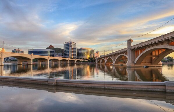 Spanning a tranquil body of water, the bridge offers a unique perspective on the city's urban landscape.