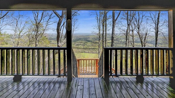 A wooden deck with a view of a forest and valley. - 5⭐️ Breathtaking Bluff Views Serene 2 Bed/2Bath Brow Cabin Cloudland near Mentone (Cloudland)