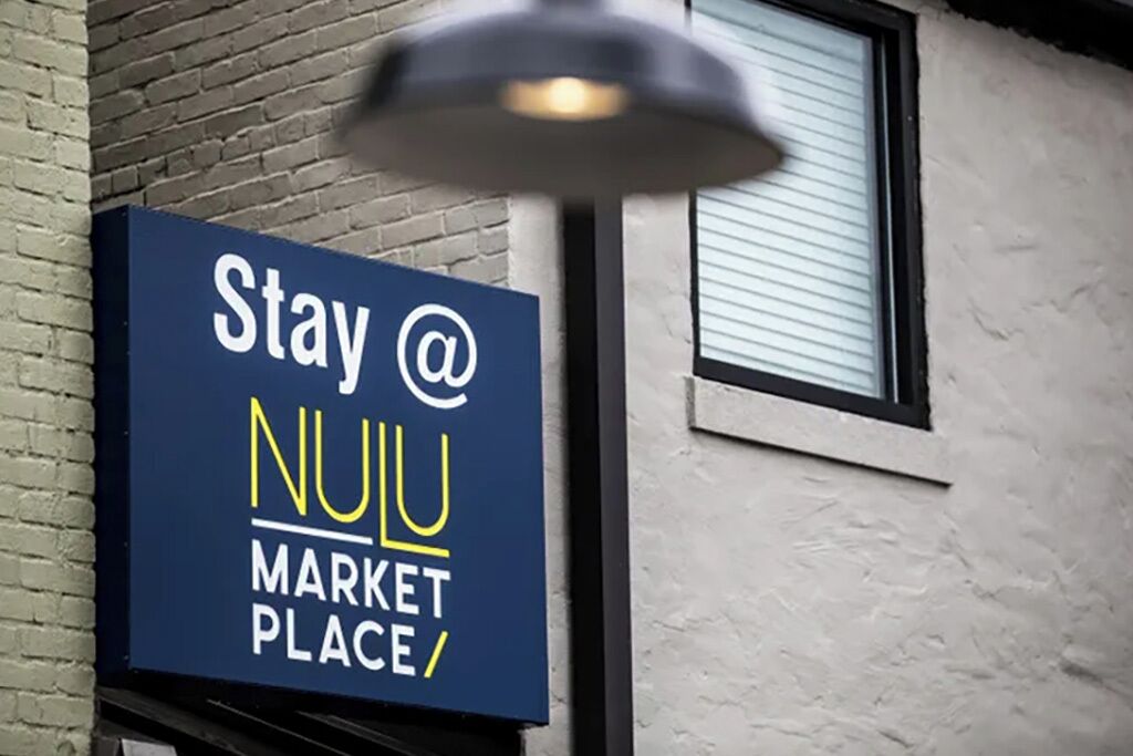 A sign for a market place with the text "Stay @ NULLU MARKET PLACE".