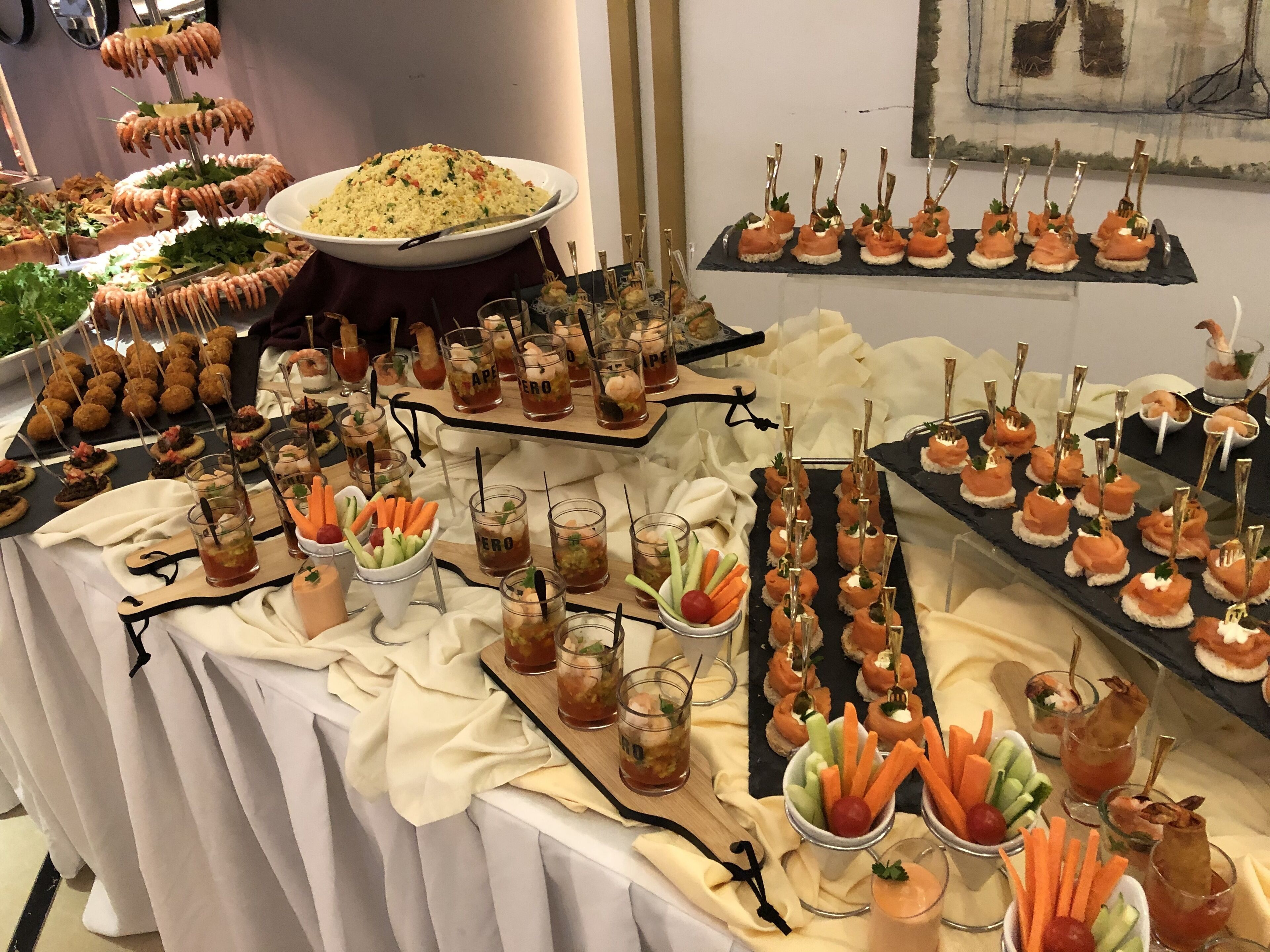 A buffet table with various food items and drinks.
