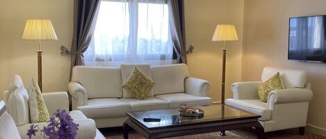 A modern living room with a sofa set, a coffee table, and two lamps.