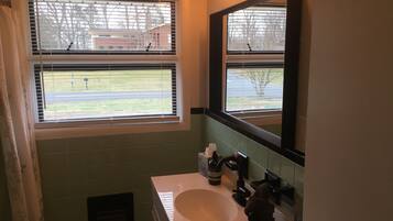Bathtub, hair dryer, towels, soap