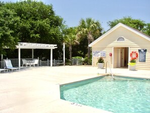 A swimming pool with lounge chairs and a lifeguard station. - Cute Family Beach Home in Wild Dunes Resort; Close to the Beach w/Porch Swing & Community Pool! (Isle Of Palms)