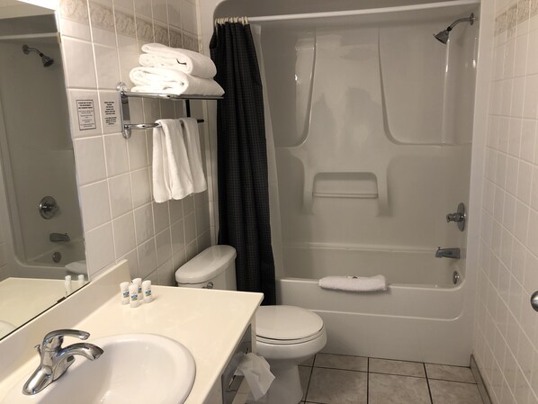 A bathroom with a sink, toilet, and shower. - Downtown Jasper Suite Beautiful Views (Jasper)
