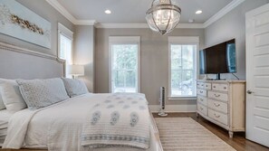 A bedroom with a bed, dresser, television, and artwork on the wall. - Luxury 4BR Home! Walk to Beach & Bike to Pool! ~ The Wander Inn at WaterSound (Santa Rosa Beach)