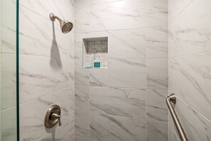 Bathtub, hair dryer, towels, shampoo