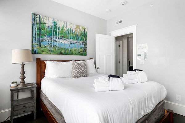 Comfort meets charm with matching nightstands, lamps, and window treatments.