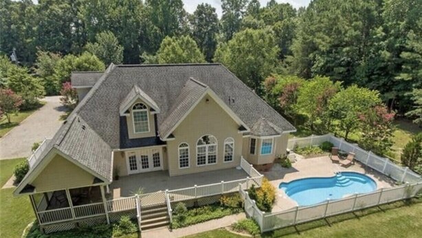 A two-story house with a large front porch, a swimming pool, and a fenced backyard. - Lazy Days Retreat (Hartfield)