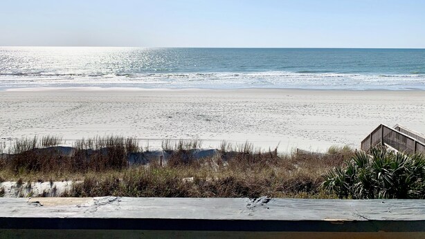 A beach with a wooden structure in the foreground.
