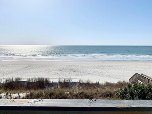 A beach with a wooden structure in the foreground. - 2 Large Bedrooms, Double Oceanfront Balcony, Full size kitchen, Pool! (Surfside Beach)