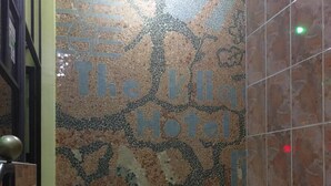 A tiled wall with the text "The Klib Hotel" and a decorative treble clef. - Klique Hotel (Eldoret)
