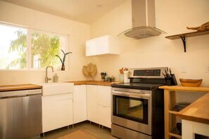 Enjoy cooking in this well-equipped kitchen with a dishwasher, oven, and stove.