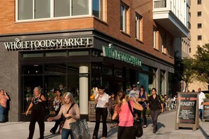A Whole Foods Market store with a brick facade and large windows. - Quiet Street by Georgetown & GWU, Free Parking + EV Charger (Washington)