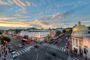 A city street at dusk with buildings, a dome structure, and a crosswalk. - Quiet Street by Georgetown & GWU, Free Parking + EV Charger (Washington)