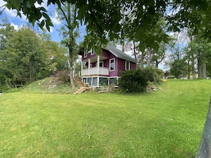 A two-story house with a front porch and a small front yard.