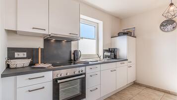 Fridge, stovetop, dishwasher, coffee/tea maker