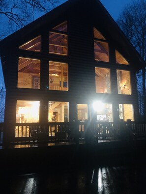 Situated in a wooded area, this cabin offers a serene setting with a cozy living space and a fireplace.