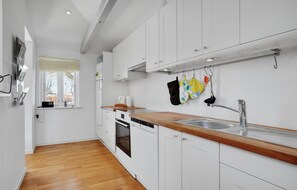 Fridge, stovetop, dishwasher, coffee/tea maker