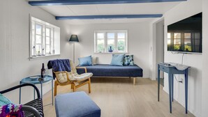 A room with a bed, a chair, a table, and a TV. - 1 bedroom beautiful home in Hjørring (Hjørring)