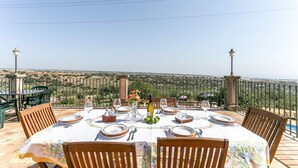 A table set for dining with a view of a rural landscape. - Stunning home in Ragusa (Ragusa)