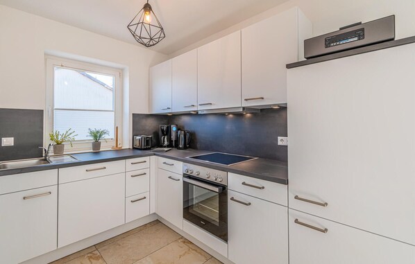 Fridge, stovetop, dishwasher, coffee/tea maker