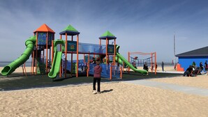 A playground with slides and climbing structures, located on a sandy beach with a clear sky. - Tall Oaks -nearby walk to  the beach -Muskegon Pere Marquette park in Bluffton  (Muskegon)