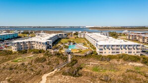 A coastal hotel with multiple buildings, a swimming pool, and a beach area. - Tommy's Bahama! in A Place At The Beach Resort on the OCEAN & the BEST pools! (Atlantic Beach)