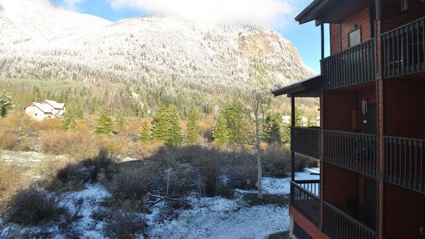 A mountain with snow-covered trees and a building with a balcony. - Mountainside condo in a Colorado playground! (Frisco)