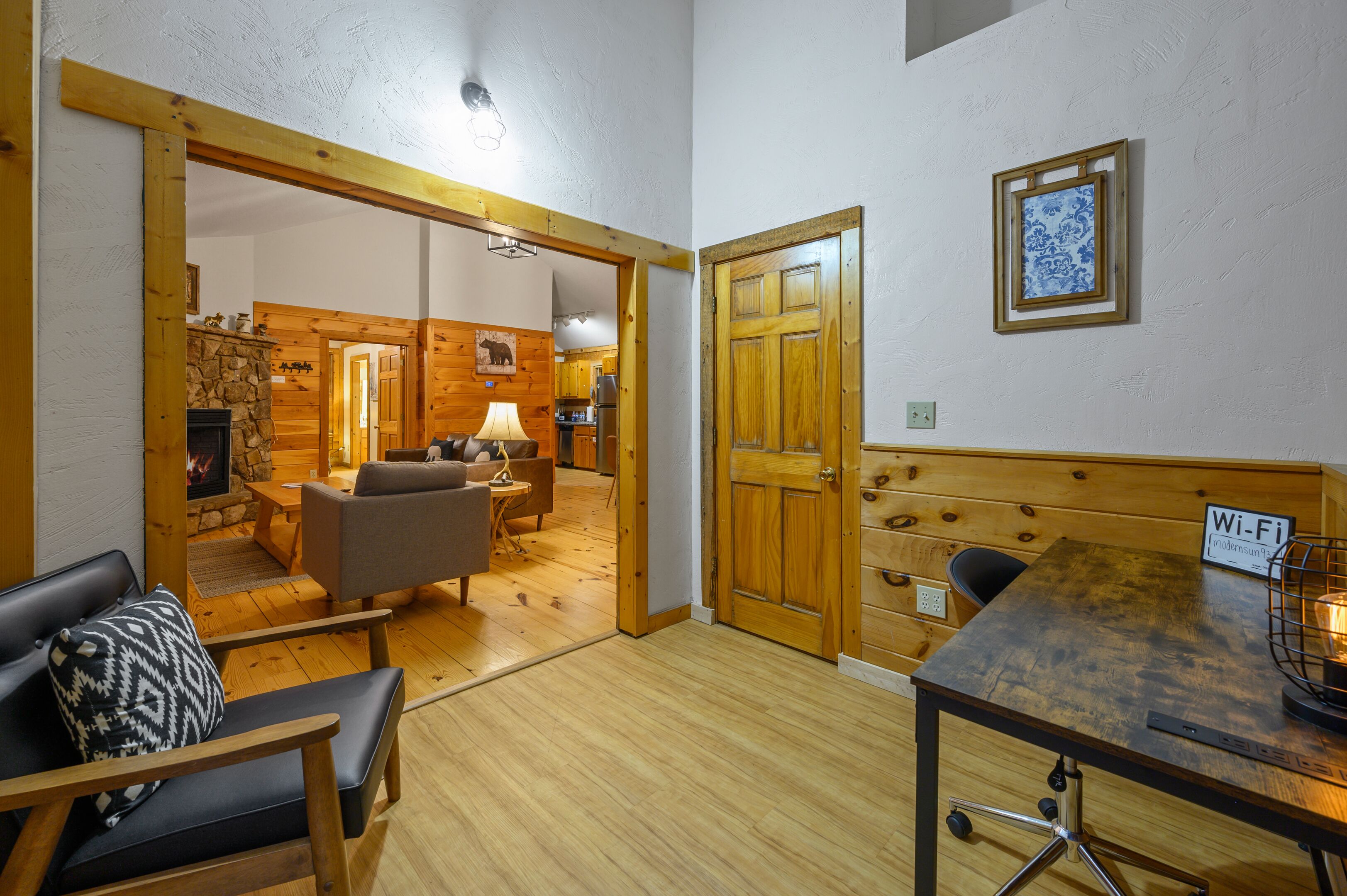 A cozy room with a fireplace, a dining table with a Wi-Fi sign, and a wooden bench.