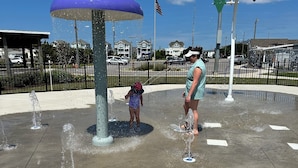 A water play area with multiple fountains and a large purple dome structure. - Oyster Pointe Flip Flop Stop Sound-side Condo (Kill Devil Hills)