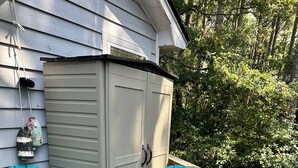 A wooden deck with two turquoise Adirondack chairs and a small table. - Oyster Pointe Flip Flop Stop Sound-side Condo (Kill Devil Hills)