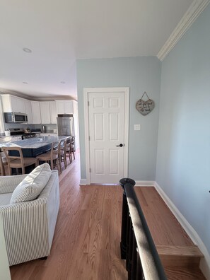 A modern kitchen with white cabinets, a stainless steel refrigerator, and a microwave. - 1 Block from Cape May Beach & 10 min. walking distance to mall- 3rd Floor Unit (Cape May)