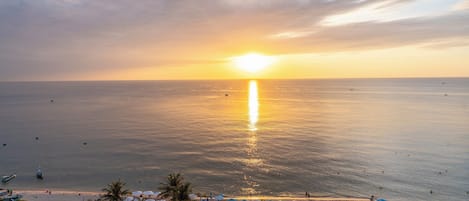 On the beach, white sand, sun-loungers, beach towels