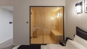 A modern hotel room with a sliding wooden door, a bedside table, a bed, and a small wooden bench in the bathroom. - Anook Hotel and Spa Daejeon Yuseong (Daejeon)