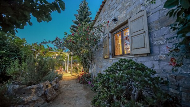 A stone building with a window and a stone wall. - Anthis Cottage (Malevizi)