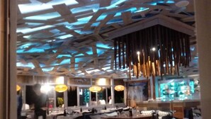 A restaurant interior with a modern ceiling design, tables, chairs, and a bar area. - Calahonda Royale Apartment Edif Lirio, Mijas Costa by Holidays & Home (Malga)