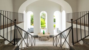 A staircase with black railings leading to an arched doorway. - Historic Charm with Modern Comfort near the Sea (Lacco Ameno)
