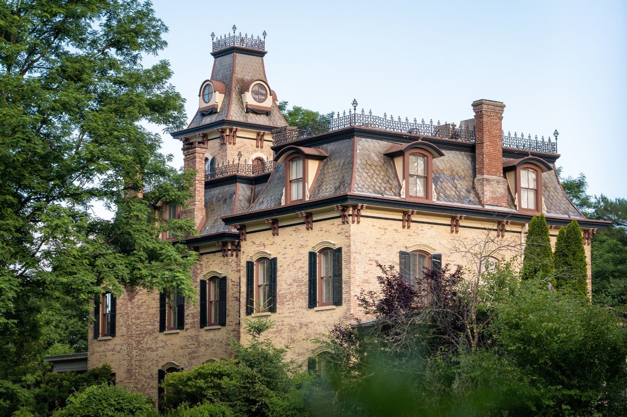 A historic building with a tower, multiple windows, and a brick facade.