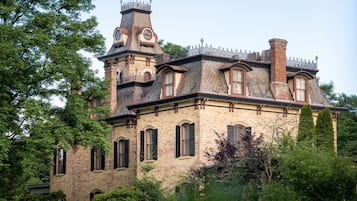 A historic building with a tower, multiple windows, and a brick facade.