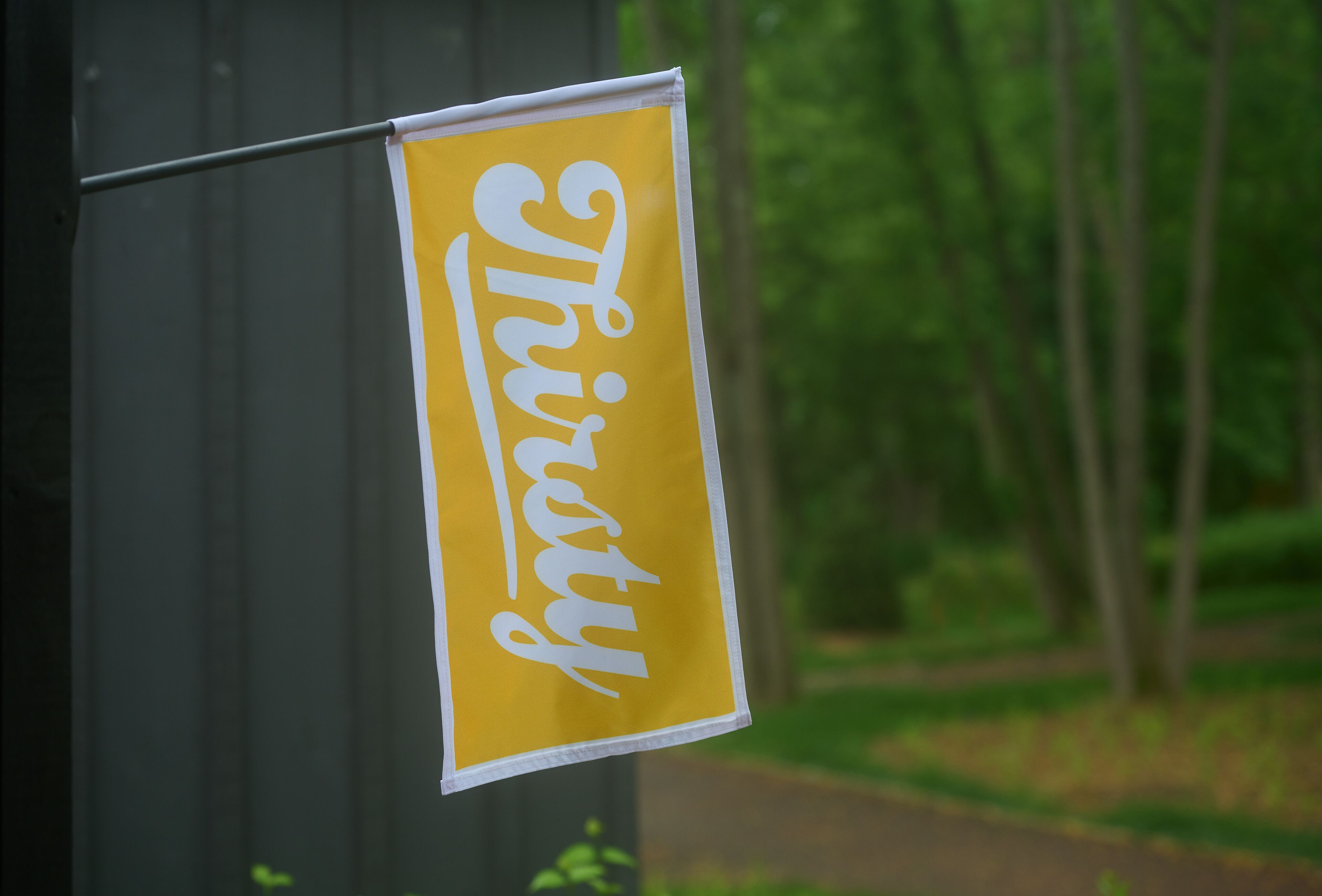 A yellow sign with the word "Thirty" in white cursive text.