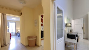 A spacious living area with a dining table, chairs, and a basket.