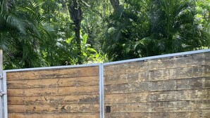 A wooden fence with metal posts, surrounded by greenery. - Award Wining Ocean View Villa - Walk to Beach (Santa Teresa)
