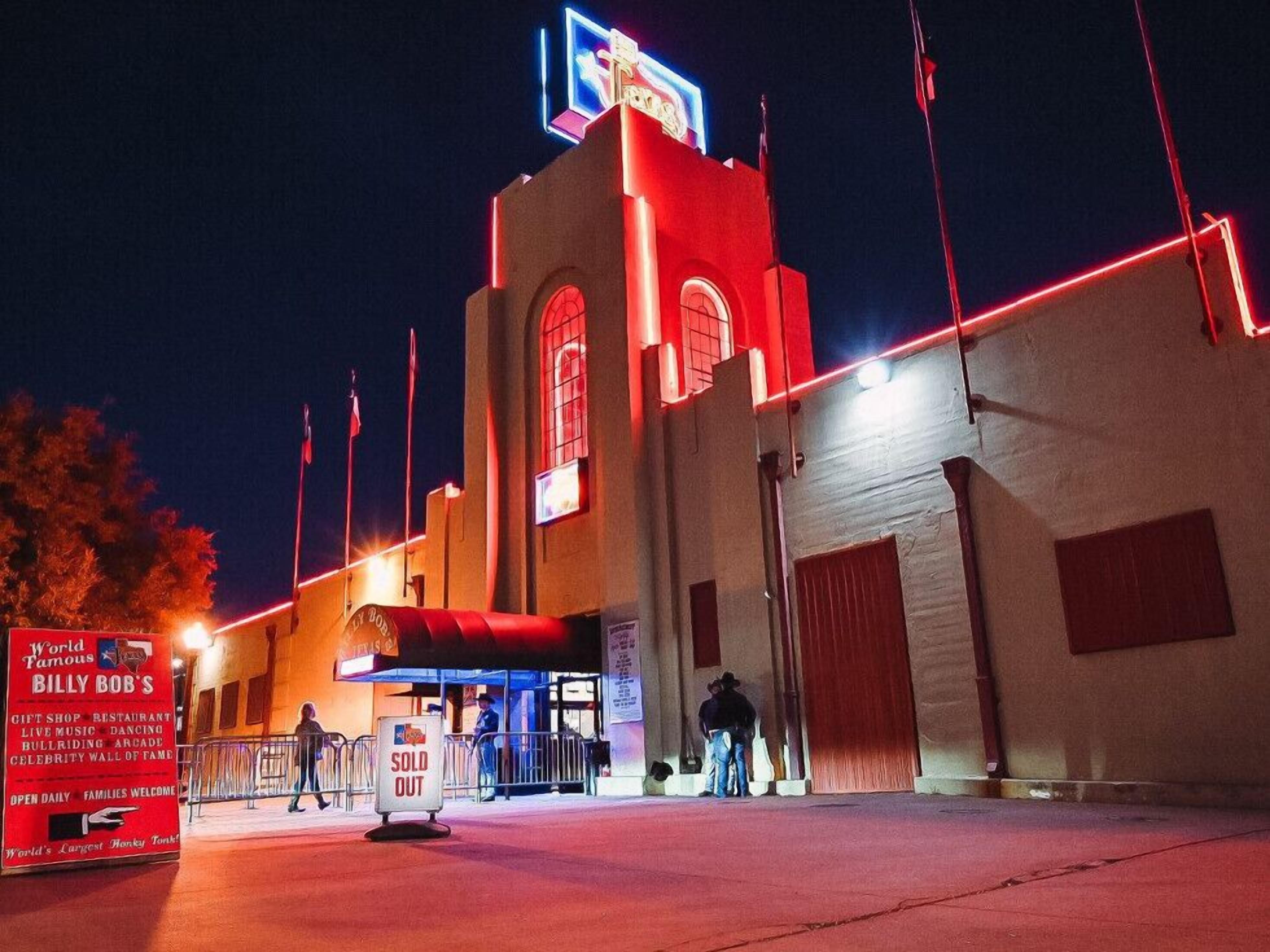 A building with a neon sign, a 'SOLD OUT' sign, and a 'World Famous Billy Bob's' sign.
