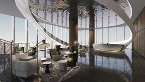 Een modern interieur met een gebogen plafond, grote ramen en een centrale zithoek met banken en tafels.