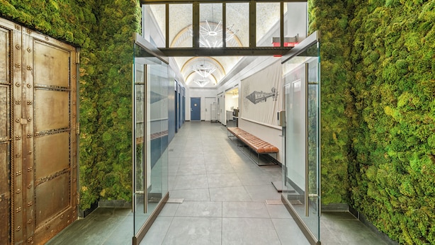 A corridor with a glass ceiling, green moss-covered walls, and a bench. - 17John  (New York)