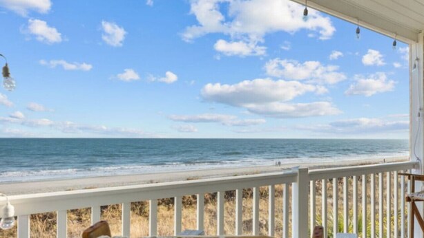 A covered porch with a view of the ocean and beach. - 2/2 Oceanfront Condo w/ Pool - Windy Hill (North Myrtle Beach)
