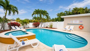 A swimming pool with lounge chairs, a hot tub, and palm trees. - Premium Luxury  5BR/4BA Villa near Hollywood Beach (Hollywood)